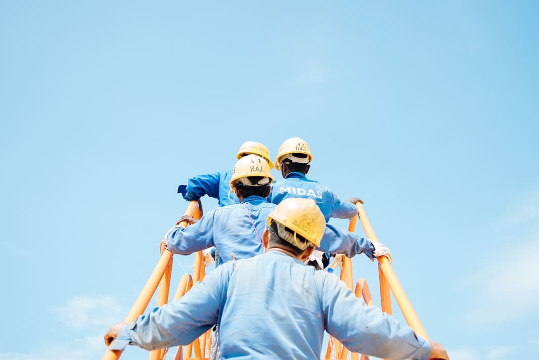 The workers climbing the steps.