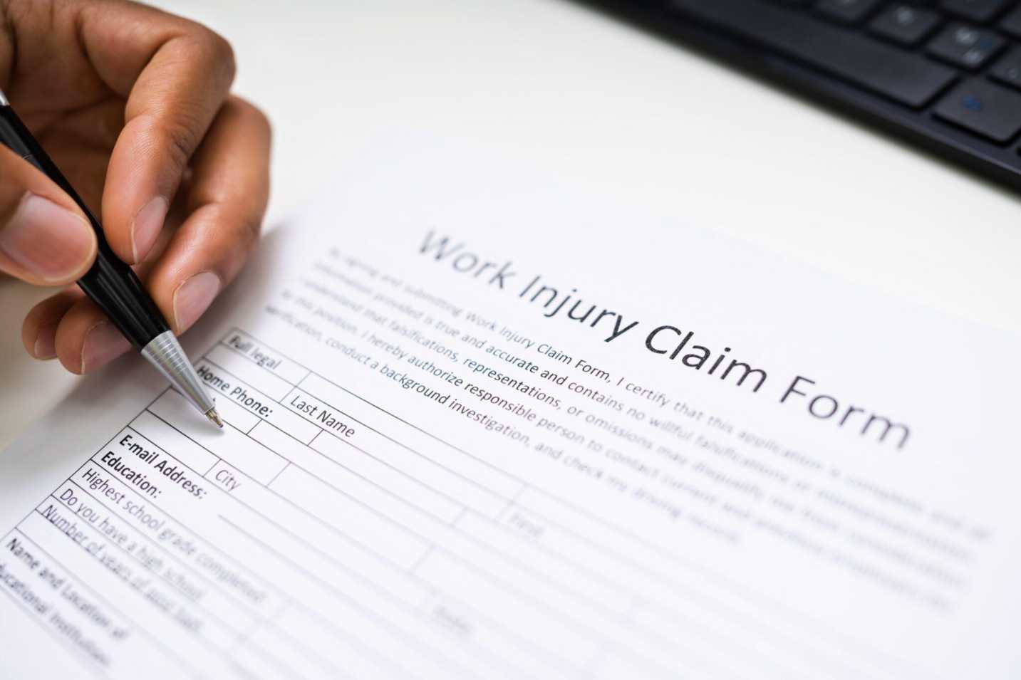 A man filling Work injury claim form at Cherry Hill, NJ