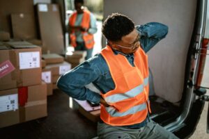 A worker experiencing neck and back pain at the work site in MD, USA