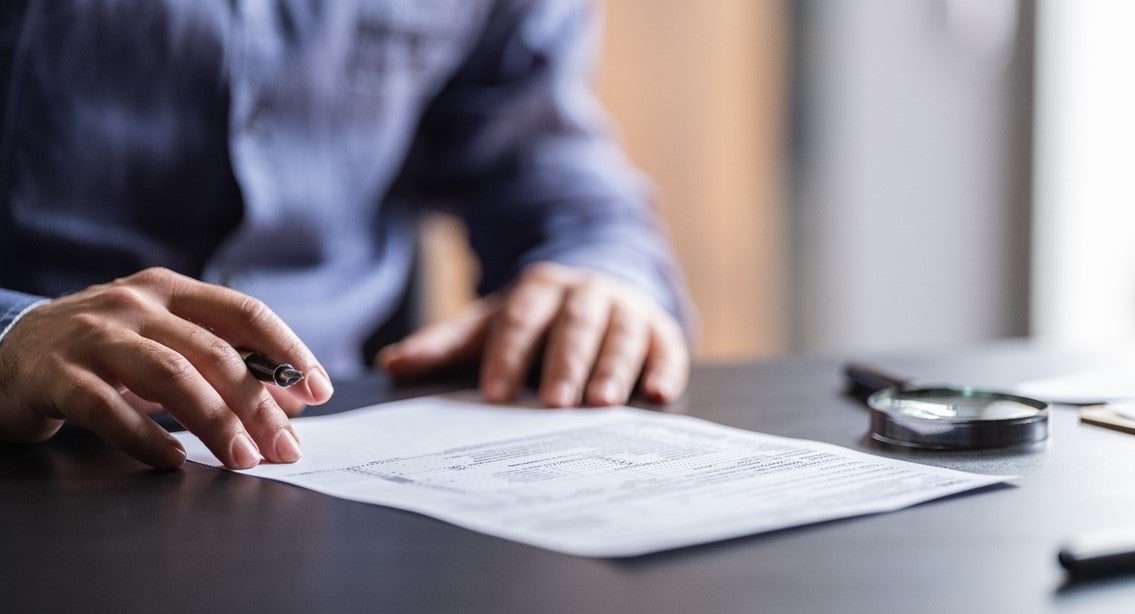 A person writing on a piece of paper
