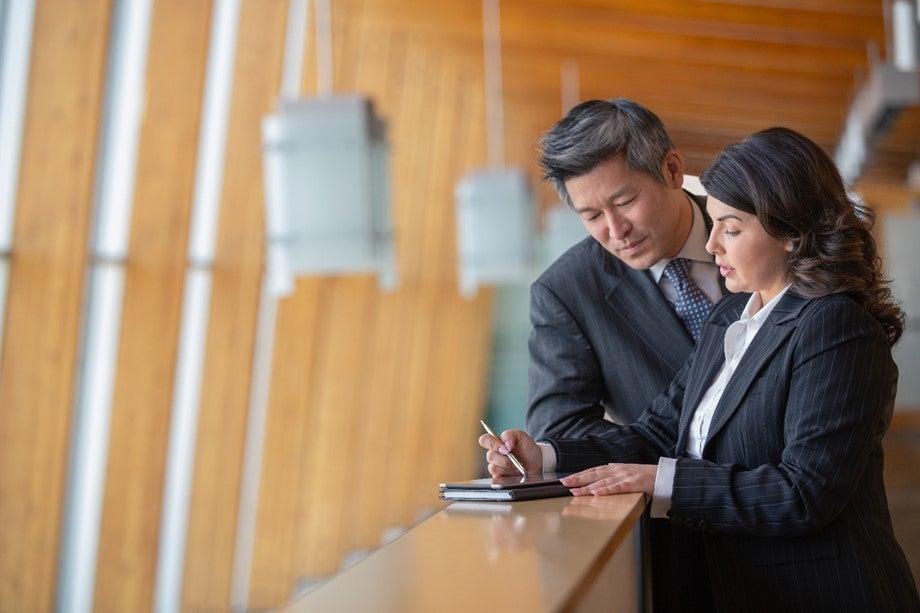 Two people looking at documentation