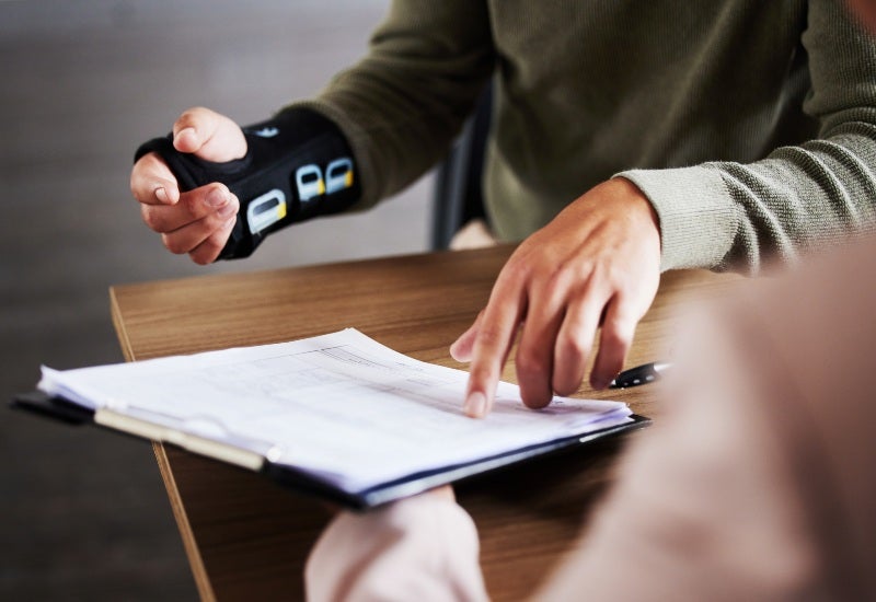The patient discussing legal options needs to be taken to a lawyer for his hand injuries.