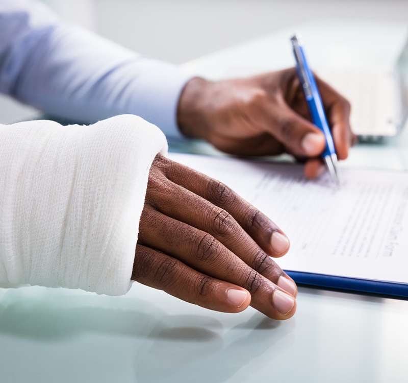 Man with broken arm reading papers