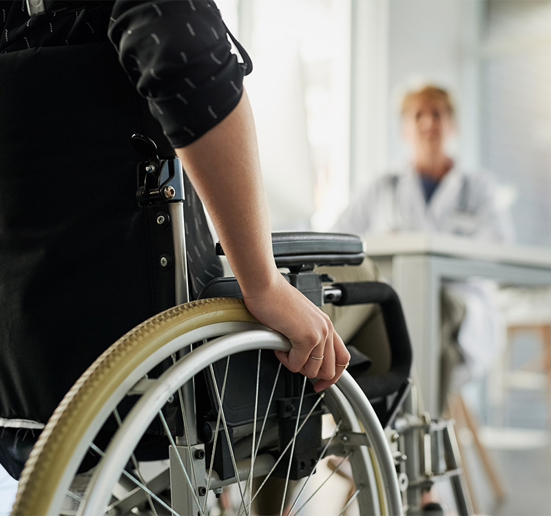 Cropped shot of an unrecognizable woman in a wheelchair visiting the doctor's rooms for a consultation