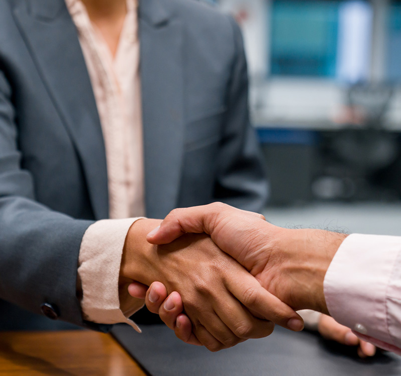 Close-up on business people closing a deal with a handshake