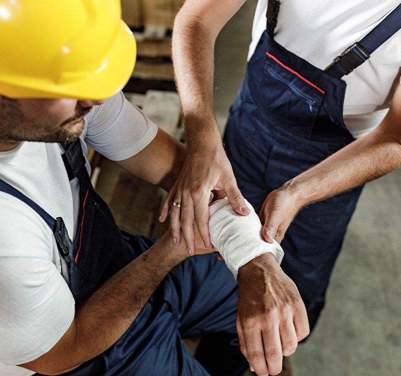 Worker taking care of coworker at worksite