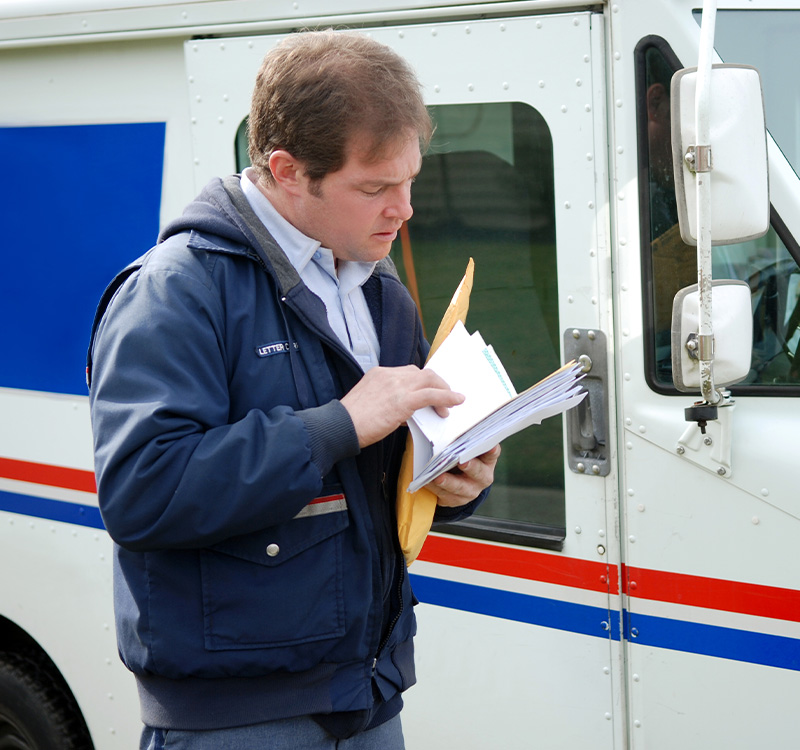 Delivery man looking at papers