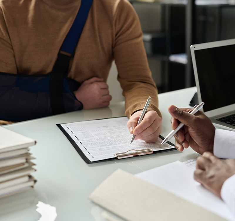 Man with broken arm reading papers