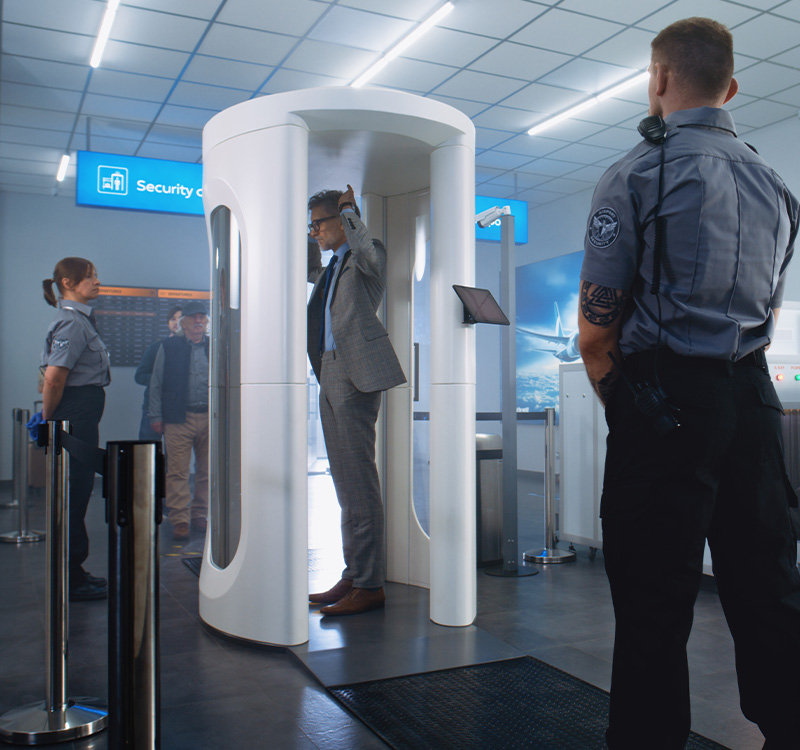 Man passes through metal detector scanner