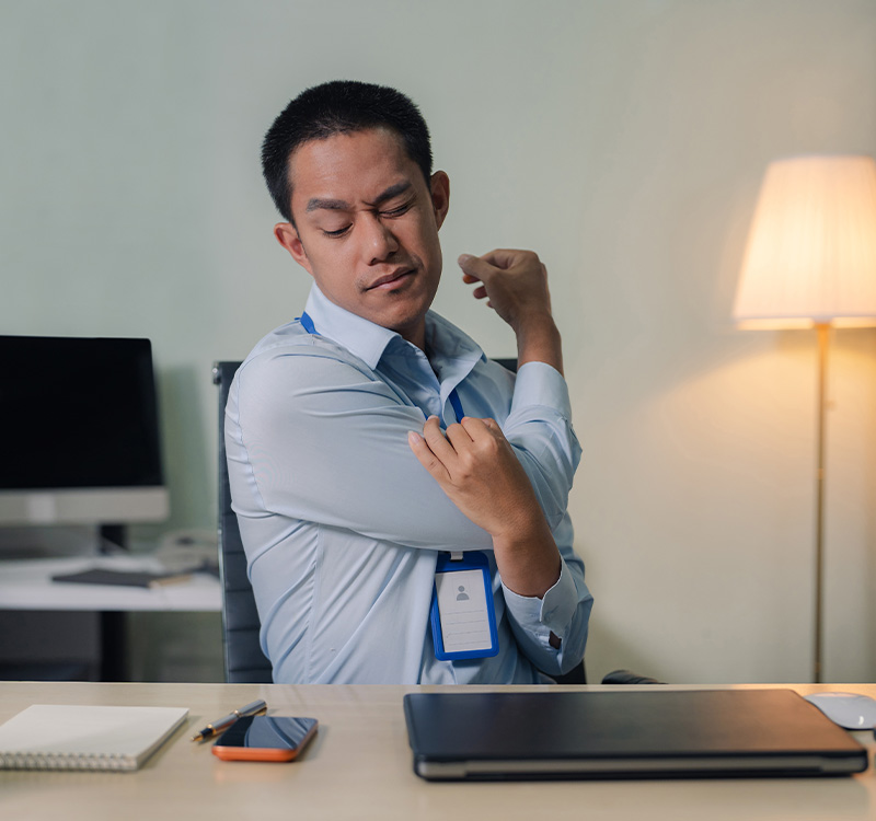 Male businessman is doing a stretchy posture due to sitting in the office for too long