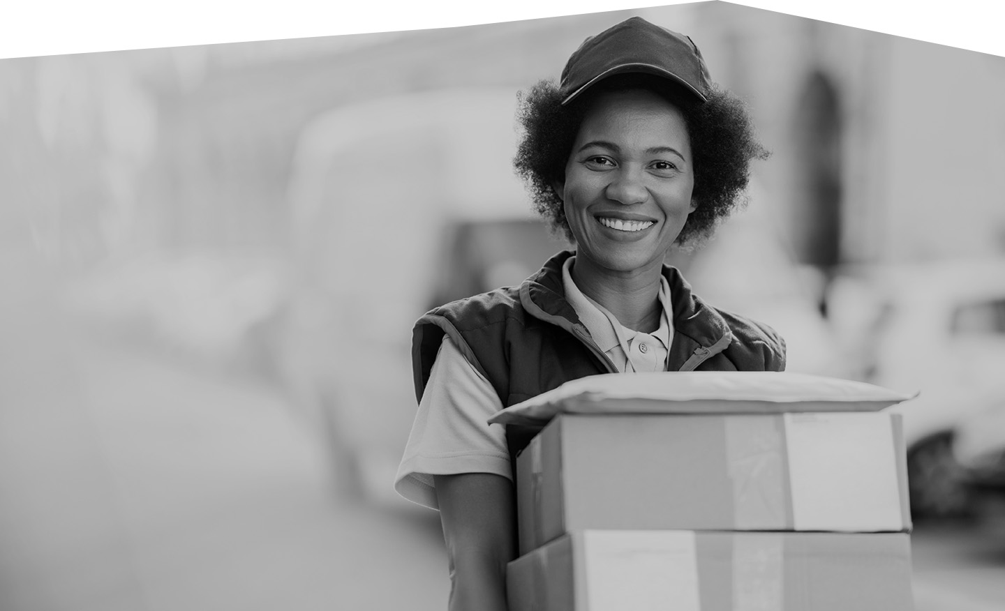 Happy African American deliverer with packages